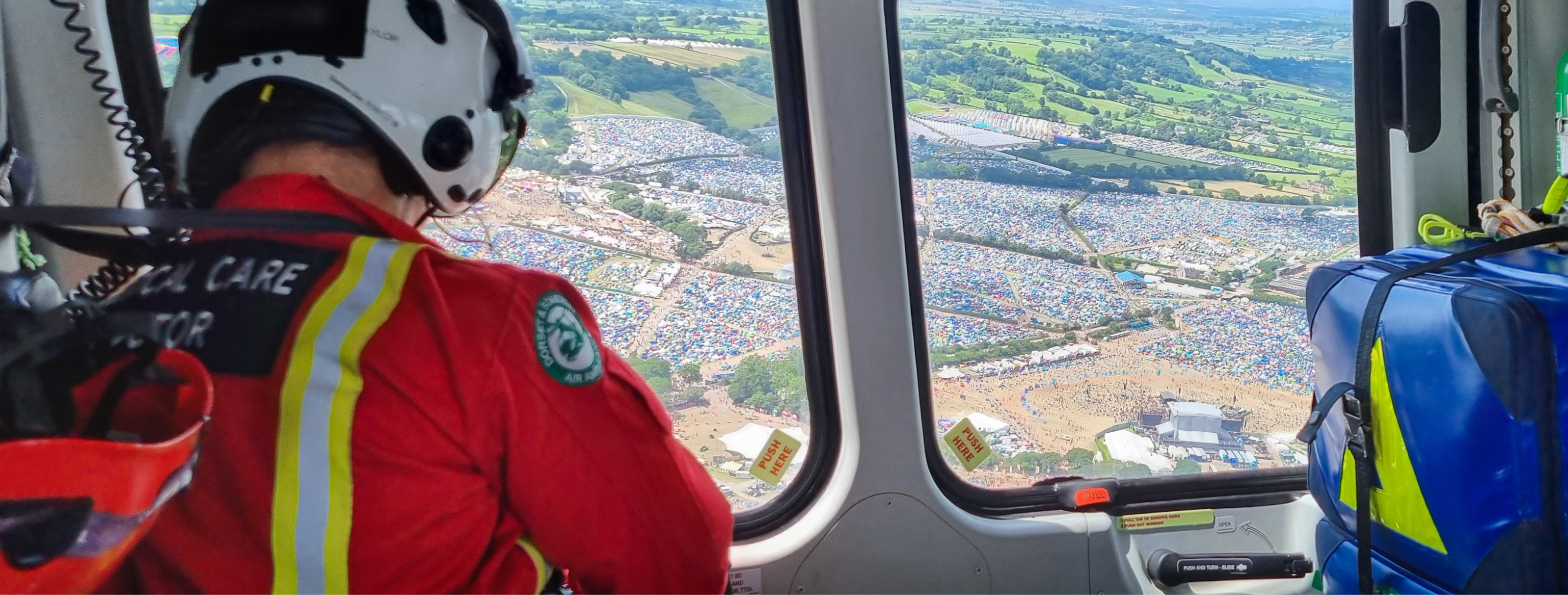 A doctor flying in an air ambulance looking down over a city