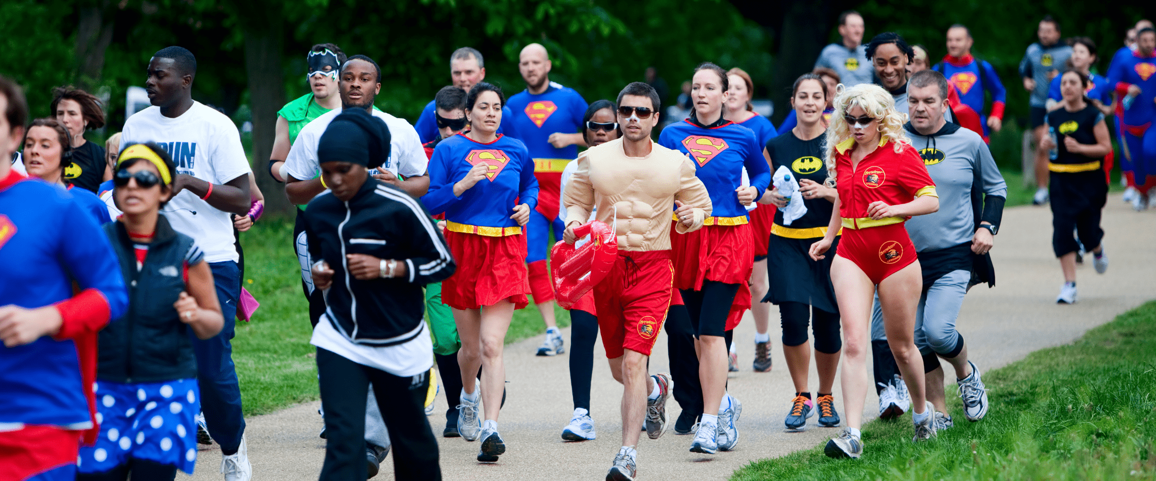 A group of people running at an event in fancy dress