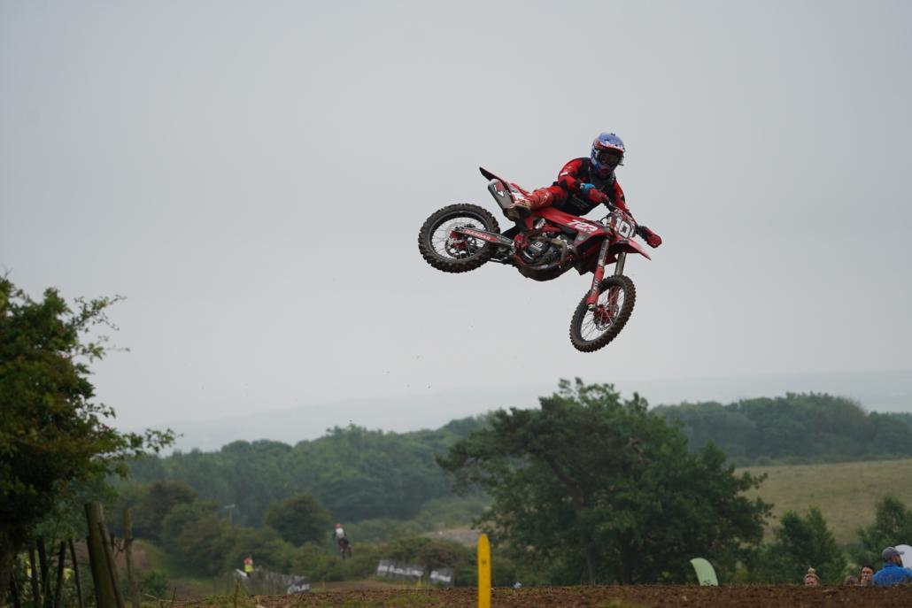 Person on a motorbike doing a stunt in mid air