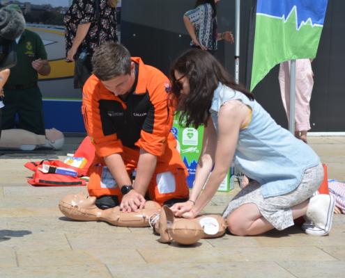 A paramedic and volunteer training to undertake CPR