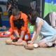 A paramedic and volunteer training to undertake CPR