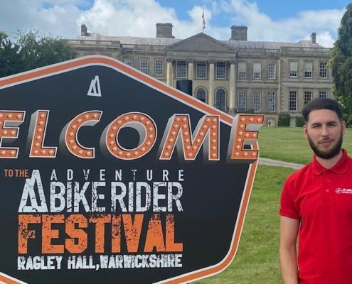 AAUK staff member and Adventure Biker Festival sign