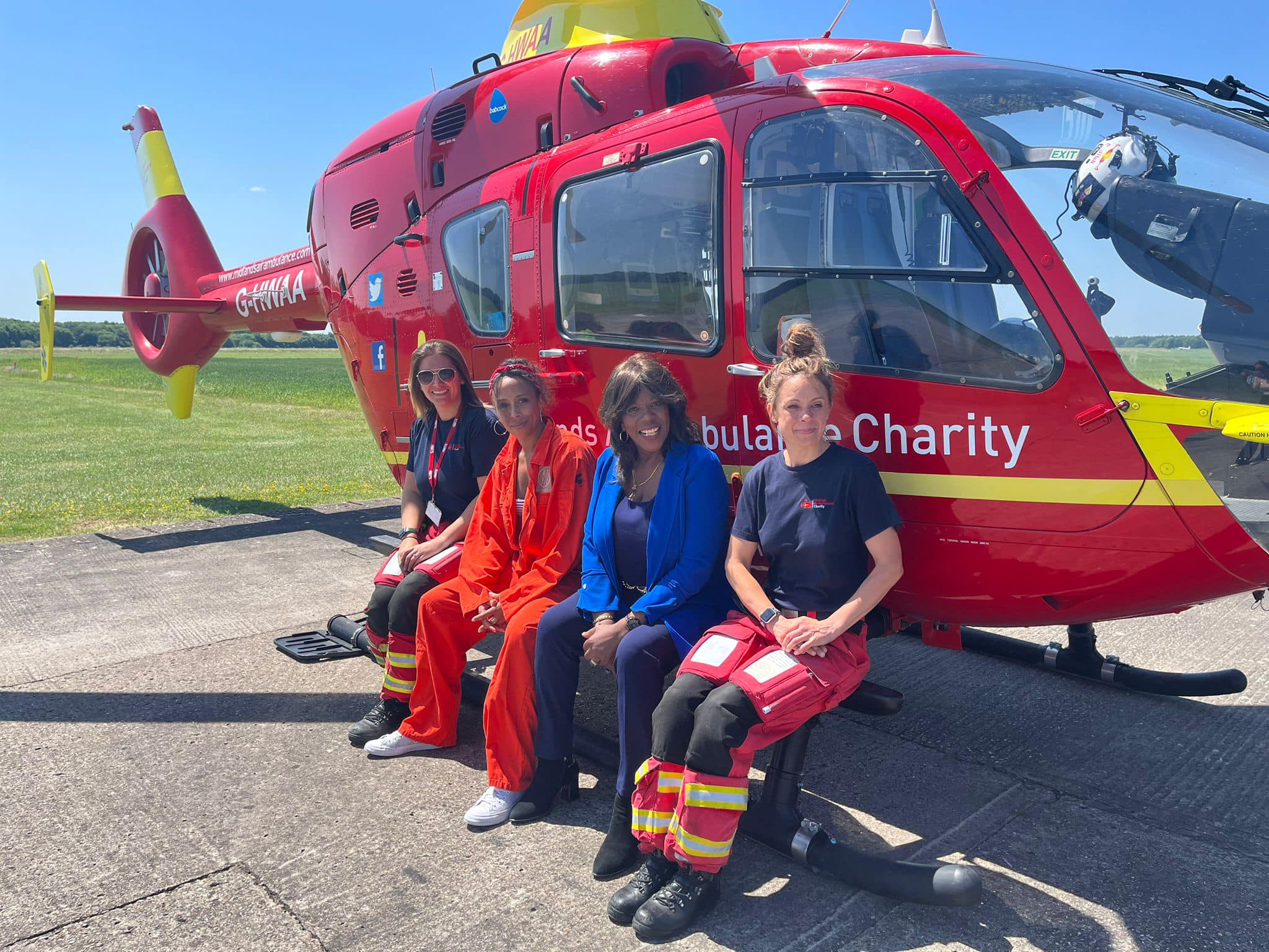 Jaki Graham pictured with the Midlands Air Ambulance Helicopter