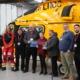Molly Photographed With Kwik Fit, Lincs & Notts and AAUK team standing next to Helicopter displaying her award.